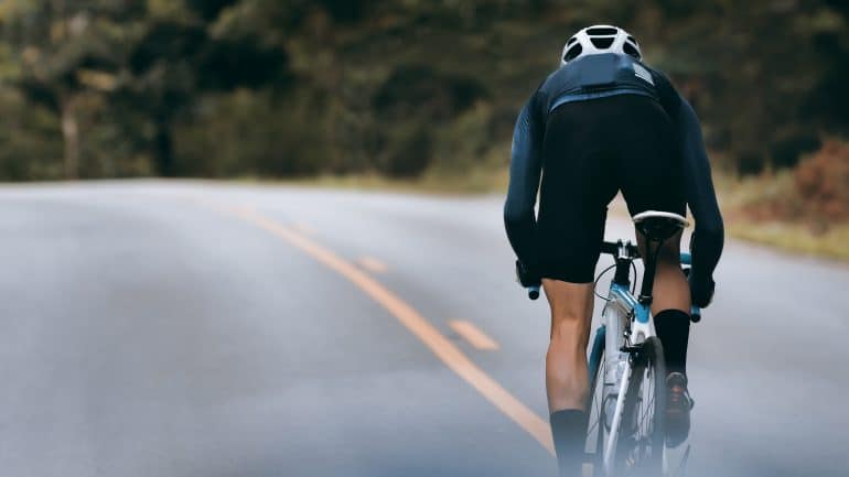 rider racing away on a smooth road